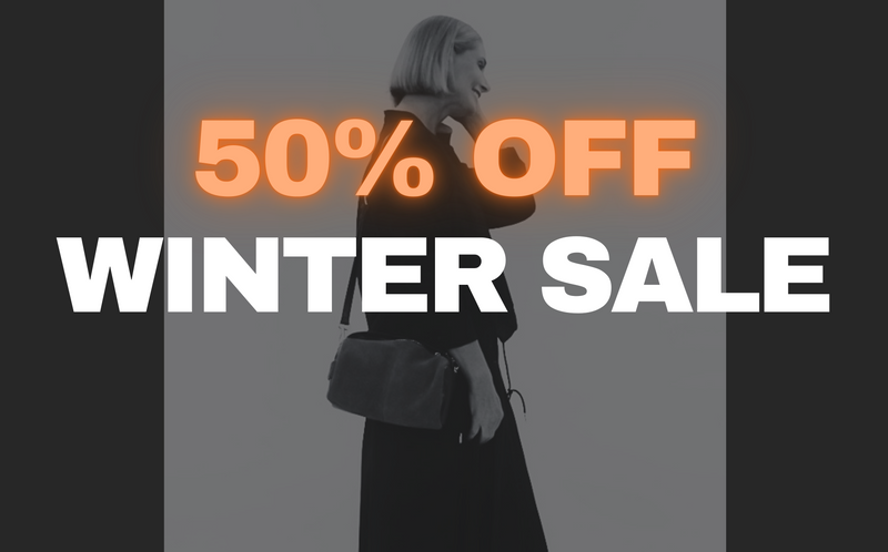 50% off Winter sale advertisement with a person holding a bag on a dark background