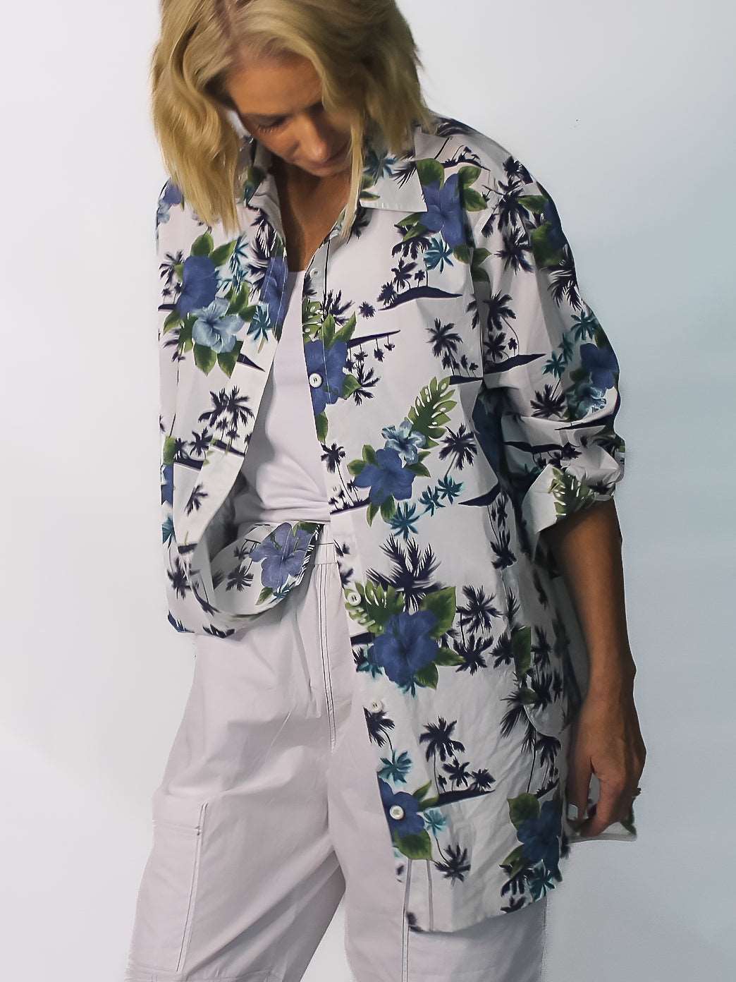 woman in white, tropical print button up shirt